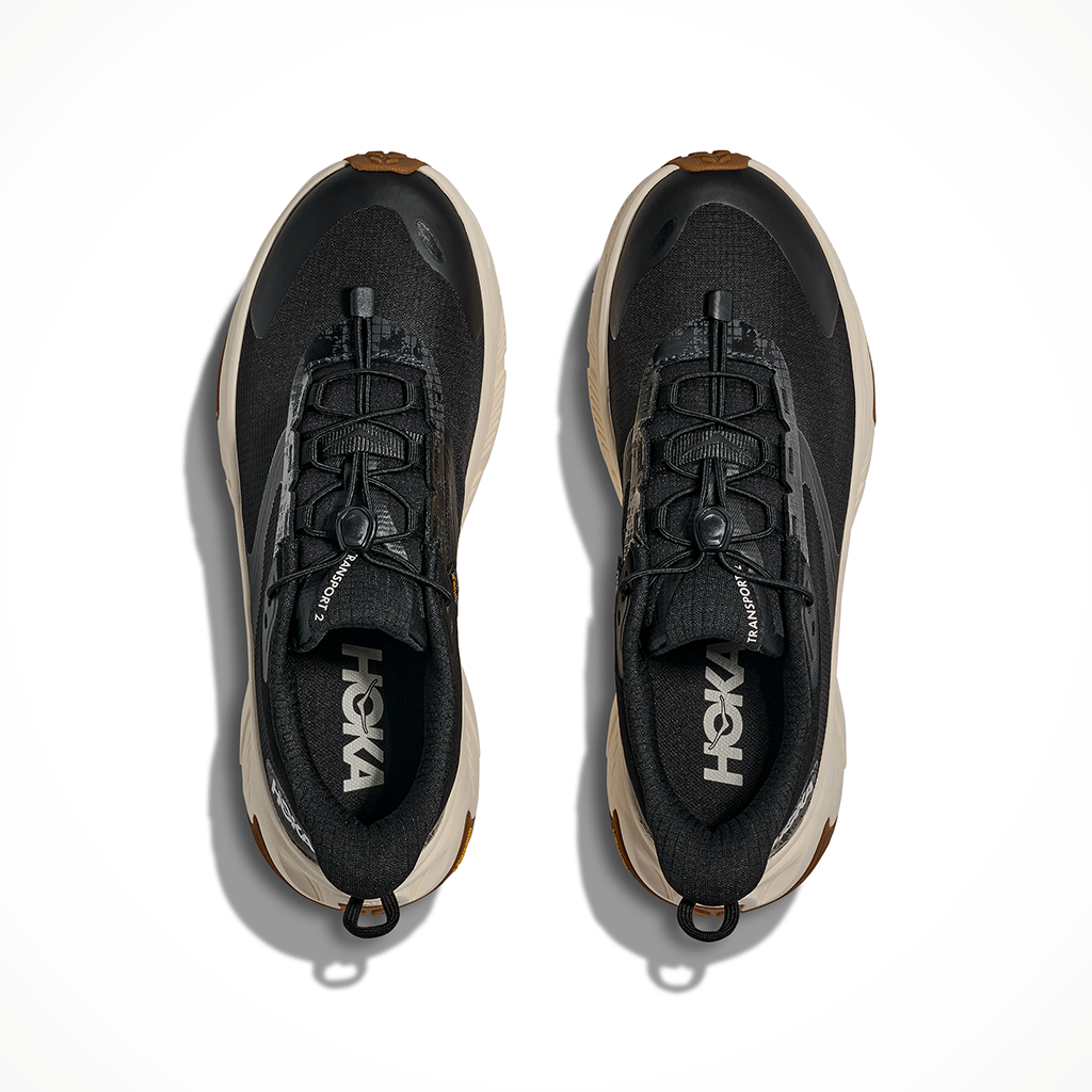 Product image: Hoka Transport 2 Black Alabaster Womens 2026, shown as a pair.
